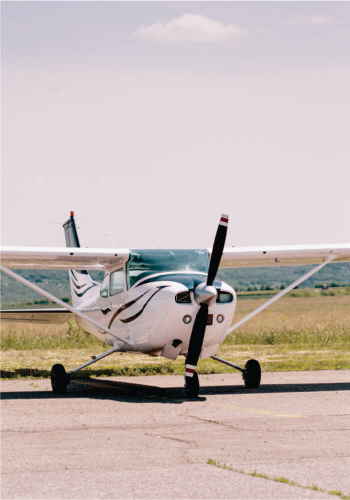 Small airplane on a runway with a clear sky background